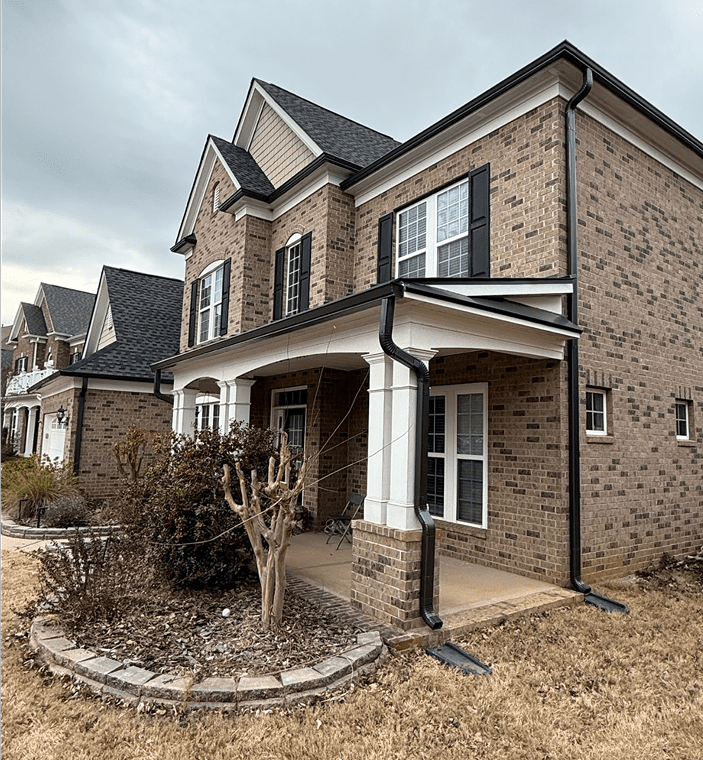 Two-story brick house with covered porch.