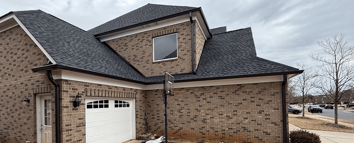 Brick house with garage and basketball hoop.